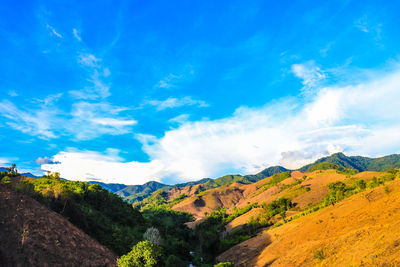 Scenic view of mountains against blue sky