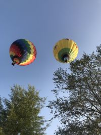 Low angle view of hot air balloons against sky