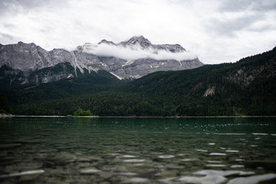 Scenic view of lake and mountains against sky