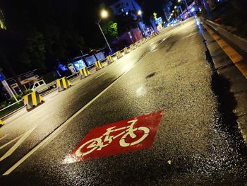 Road sign on street in city at night