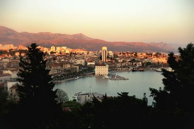 City at waterfront during sunset