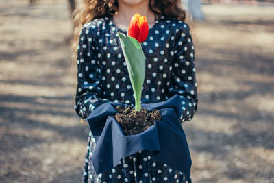 Rear view of woman standing outdoors