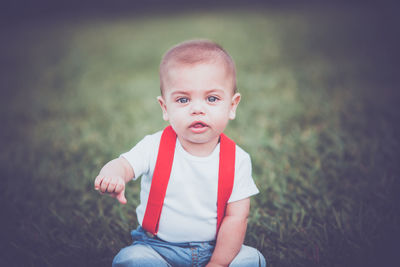 Portrait of cute girl sitting on land