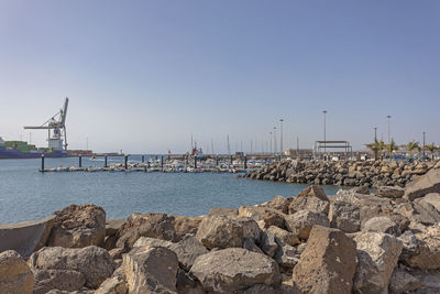 Sailboats on sea against clear sky