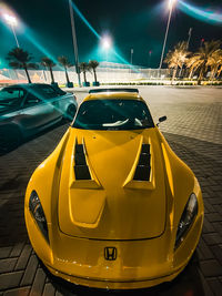 Close-up of yellow car on road at night