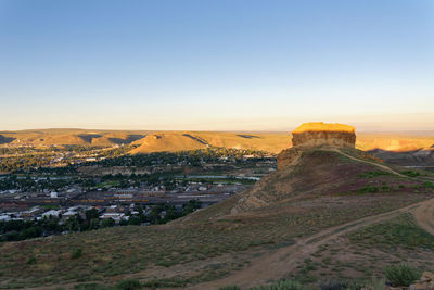 Scenic view of landscape against clear sky during sunset