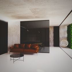 Empty chairs and table against wall in house