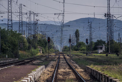 Railroad tracks amidst trees against sky