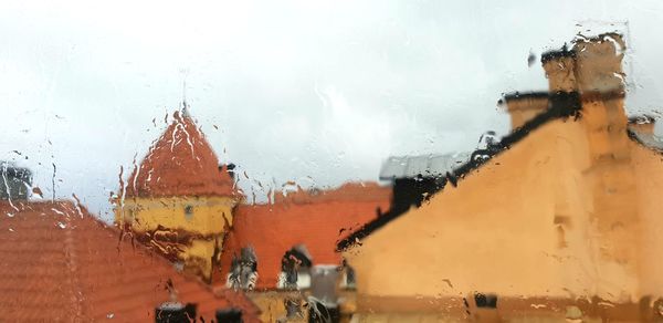 Close-up of wet glass window during rainy season