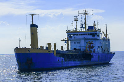 Ship sailing in sea against sky