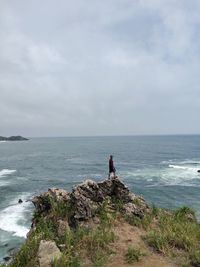 Man looking at sea against sky