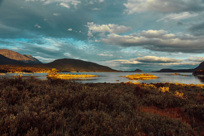 Scenic view of lake against cloudy sky