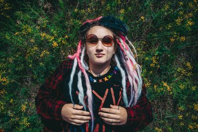 Portrait of young woman wearing sunglasses standing outdoors