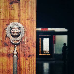 Old antique knocker and handle on wooden door