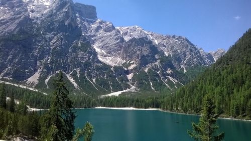 Scenic view of lake and mountains against clear sky