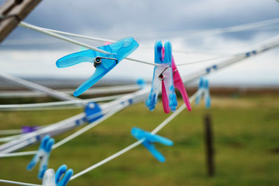 Close-up of multi colored clothespins on clothesline