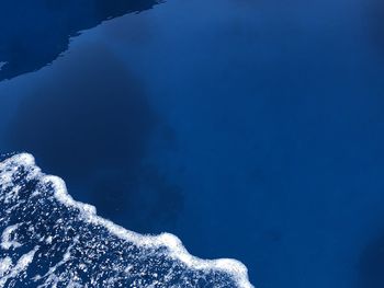High angle view of sea against blue sky