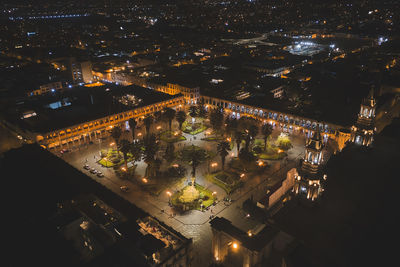 High angle view of illuminated buildings in city at night