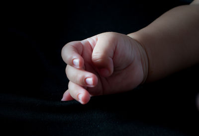 Close-up of young woman holding hands