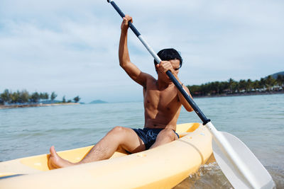 Low section of woman kayaking in lake