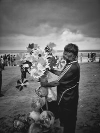 People at beach against sky