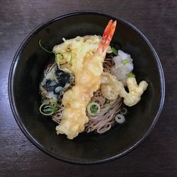 Directly above shot of fried prawn with soba noodles in container on table