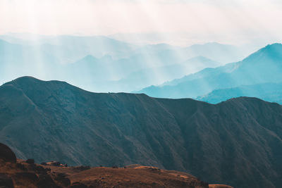 Scenic view of mountains against cloudy sky