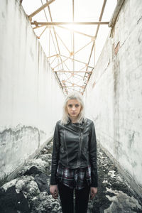 Portrait of young woman standing in snow