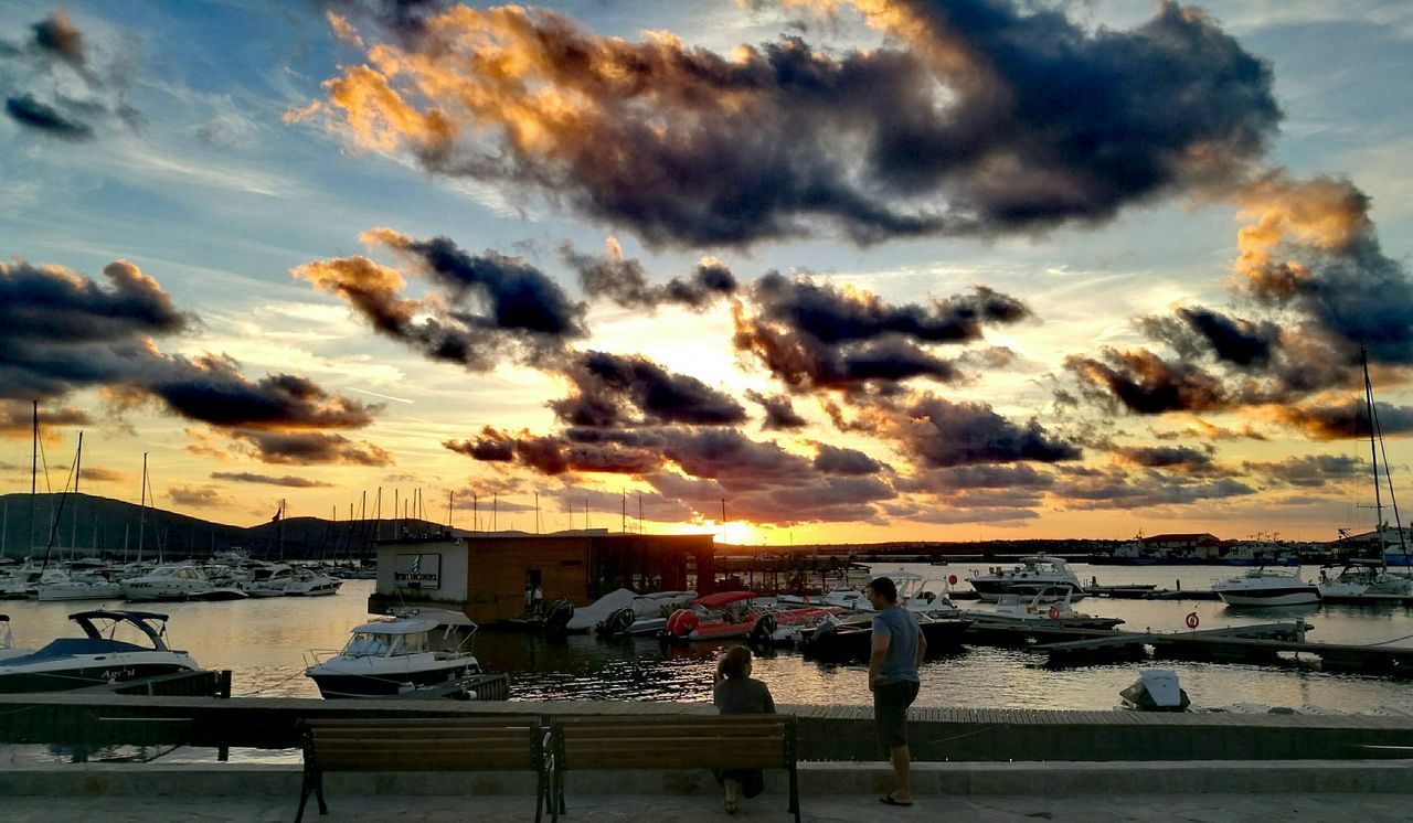 SAILBOATS MOORED AT HARBOR