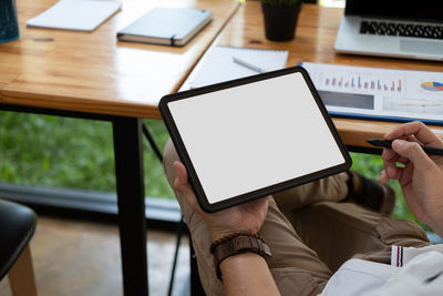 Low section of person using laptop on table