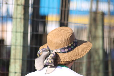 Rear view of woman wearing hat on floor