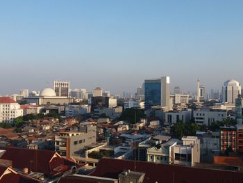 High angle view of buildings in city against clear sky