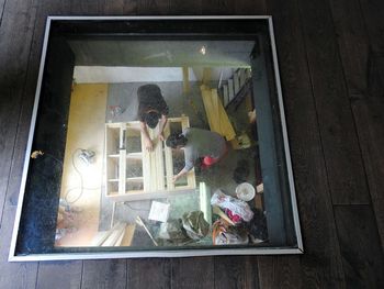 Man photographing through window