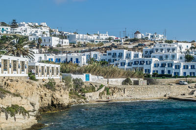 Summer waterfront at the mediterranean sea and cityscape buildings of mykonos, greece.