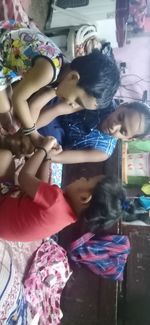 Rear view of a girl holding people