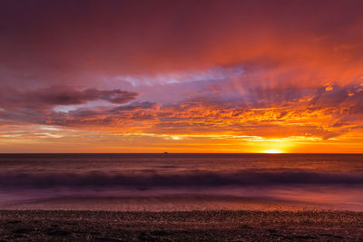 Scenic view of sea against romantic sky at sunset