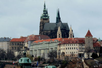 Low angle view of st vitus cathedral and buildings against sky