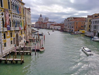 View of boats in canal along buildings