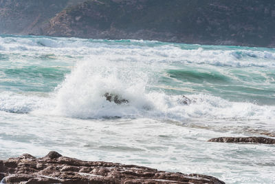 Waves breaking on rocks