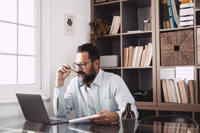 Man using laptop while sitting at home