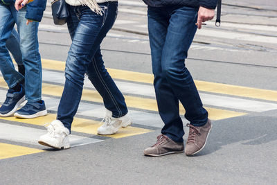 Low section of people standing on road