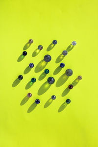 High angle view of colored pencils on yellow background