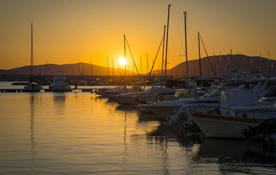 Sailboats in marina at sunset