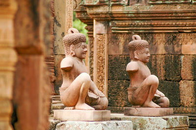 Statue against historic building