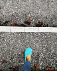 Low section of woman standing on ground