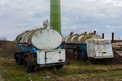 Abandoned truck on field against sky