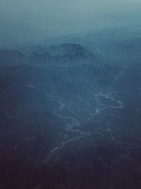 Atmospheric aerial shot of mountains and village