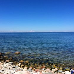 Scenic view of sea against blue sky