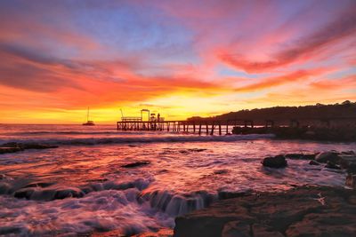 Scenic view of sea against orange sky