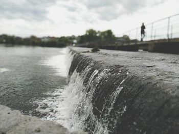 Close-up of water splashing in river against sky
